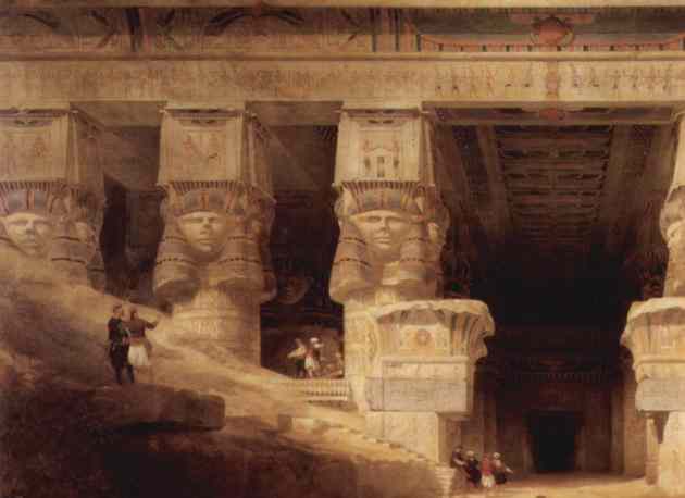 Dendera courtyard, upper Egypt. Re-imagined Hathor faces look out from the tops of giant columns.