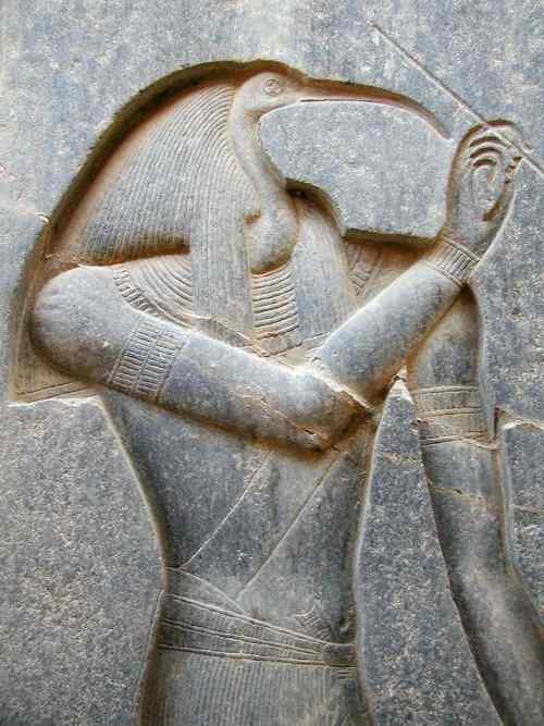 Thoth has the head of a long-billed bird (ibis) and carries a stylus.